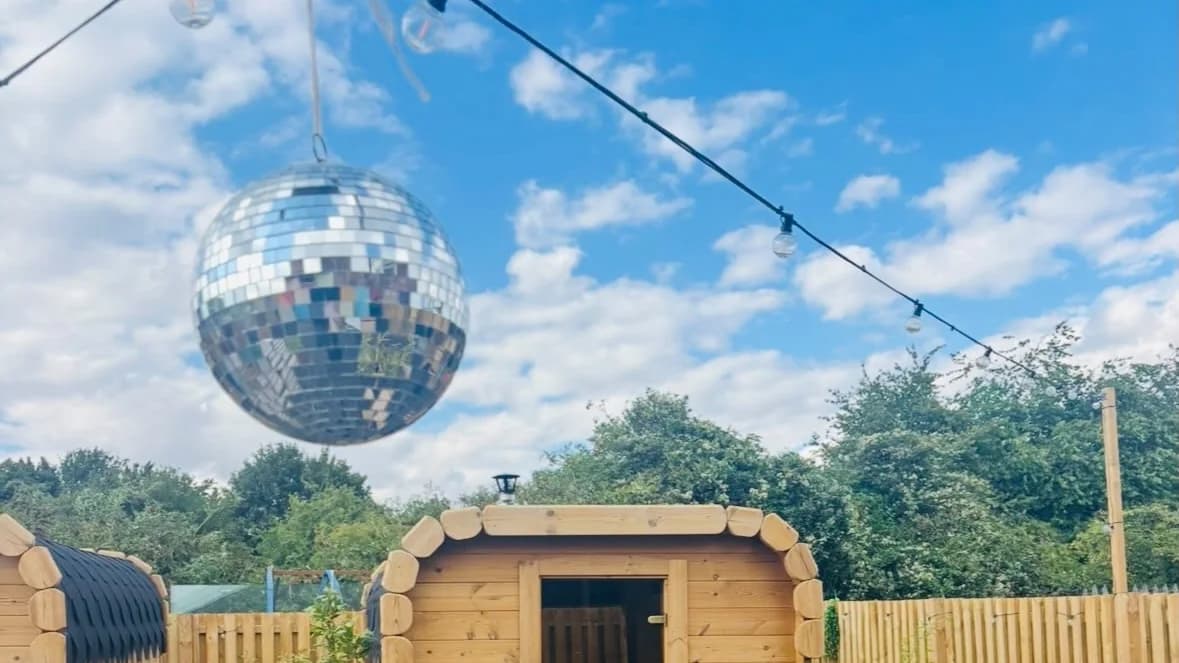 Large disco ball above the outdoor sauna at Fuse Saunas
